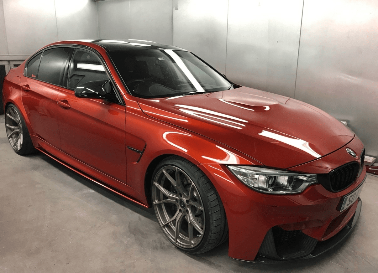 Red BMW after refinishing in the spray booth