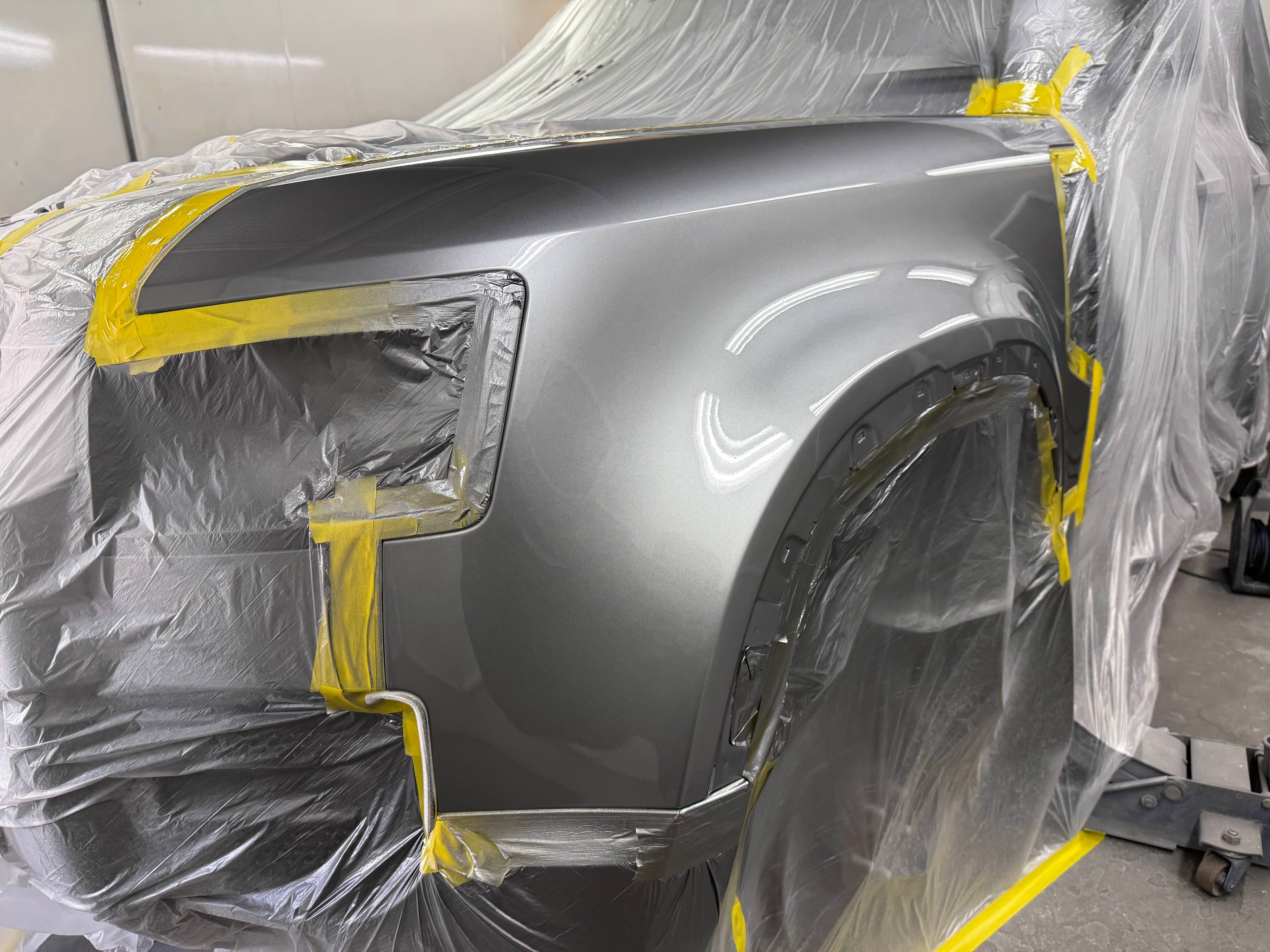 Repaired grey front wing masked after respray